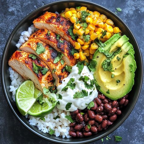 🍚🌽 Savor the flavors of street food with our Street Corn Chicken Rice Bowl! A fiesta in every bite! 🌶️ #StreetFoodStyle #DeliciousEats Street Corn Chicken Rice Bowl Ingredients: Chicken breast (2, grilled and sliced) Rice (2 cups, cooked) Corn kernels (1 cup, roasted) Black beans (1/2 cup) Avocado (1, sliced) Cotija cheese (1/4 cup, crumbled) Lime (1, juiced) Cilantro (for garnish) Sour cream (2 tbsp) Chili powder (to taste) Instructions: Arrange rice in bowls. Top with grilled chicken, r... Cuban Chicken Rice Bowl, Grilled Chicken With Rice Recipes, Healthy Chicken Ideas For Dinner, Cilantro Rice Bowl, Rice And Avocado Bowl, Chimichurri Chicken Bowl, Veggie Chicken Bowl, Meal With Avocado, Healthy Greek Chicken Bowls