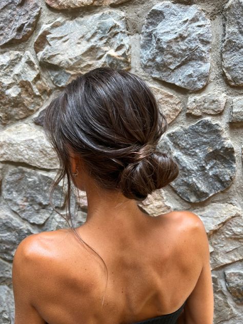 Prom Simple Updos, Dark Hair Low Bun, Prom Updos Simple, Low Bun With Loose Curls, Minimal Bridesmaid Hair, Simple Bun For Wedding Guest, Undone Bun Wedding, Effortless Low Bun Wedding, Effortless Bun Hairstyles