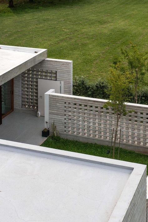 Unique Concrete Walls Act As A Privacy Fence And Allow The Breeze To Pass Through At This Home Breeze Block Entrance, Concrete Fence Wall, Concrete Wall Design, Fence Wall Design, Breeze Block Wall, Compound Wall Design, Concrete Block Walls, Entrance Wall, House Fence Design