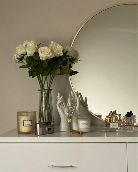 White aesthetic bedroom decor
White dresser
White flowers
Big circle mirror
Clean girl aesthetic 
Minimalist decor
Perfume display
Pearl necklace display
Bedroom ideas
Room ideas
Home decor
Dorm decorations 
College girl bedroom
Soft girl decor Classy Room Decor, Classy Dorm Room, Nail Suite, Dresser Decor Bedroom, Bedroom Things, Classy Rooms, Gold Rooms, Comfy Bedroom, Classy Bedroom