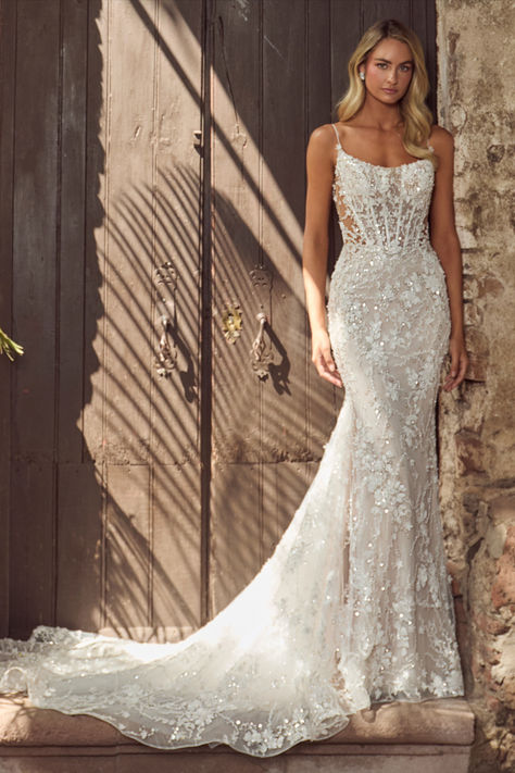 In this wedding dress with an overskirt,there’s no doubt in our minds that you’ll evoke the same majesty of Hera and feel just as beautiful as the goddess herself.Featuring a sheath silhouette adorned with sparkling sequins and intricate lace,this dress transforms with a detachable overskirt,making the arrival at the reception even more breathtaking.Her spaghetti straps create an airy feel, while her low back exudes allure, allowing brides to glide down the aisle while  blending sophistication. Strappy Sheath Wedding Dress, Mermaid Wedding Dress Corset Top, Lace Sparkly Wedding Dress, Floral Lace Wedding Dress Fitted, Fitted Wedding Dress Sparkle, Simple Bodycon Wedding Dress, Wedding Dresses Fitted Lace, Fitted Sparkly Wedding Dress, Wedding Dresses With Overskirt