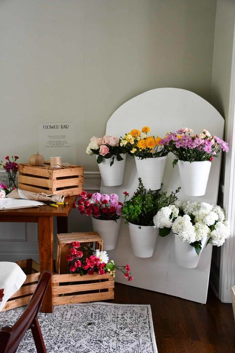 Make a gorgeous flower bar with a foam board backdrop! This DIY was under $50 and a great way to create an activity and favors at a shower. Wooden Flower Holder, Diy Flower Bucket Stand, Galentines Party Flower Bar, Party Favors Bridal Shower Ideas, Diy Bouquet Station, Bridal Shower Diy Decor, Succulent Bar Diy, Flower Bar Birthday Party, Diy Bloom Bar