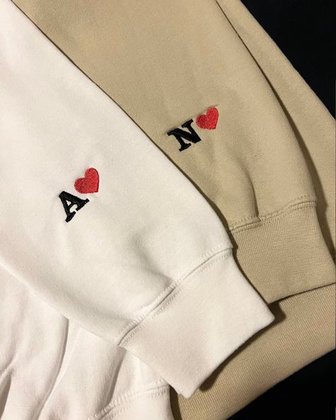 Best gift idea for your love,hand embroidery 🧵 Dm for enquiry All size available Custom Embroidered Initial Heart Sweatshirt, Initial Hoodie Sleeve, Embroidered Sleeve Sweatshirt, Embroidery Personalized Gifts, Sweatshirt Sleeve Embroidery, Anniversary Gifts For Her Romantic, Sleeve Embroidery Designs, Embroidery Designs Sweatshirt, Matching Sweatshirts For Couples