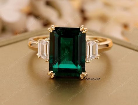 "★ RING INFORMATION ★ ------------------------------------------------------------------- ★ MAIN STONE ➺ SHAPE  :- Emerald Green cut  (lab created) ➺ Weight :- 4.90 ct (11 x 9 mm) (app.) ➺Gem color :  Green ➺Luster: Excellent ➺ Make: High Quality ➺Clarity : VVS ------------------------------------------------------------------- ★ SIDE DIAMOND  ➺ SHAPE  :-Trapezoid Cut Moissanite  ➺ Weight :- 0.50ct  ➺Gem color :  White/ Colorless ➺Luster: Excellent ➺ Make: High Quality ➺Clarity : VVS ------------------------------------------------------------------- ★ BAND  ➺ BAND WIDTH :- 1.8 mm  ➺ BAND THICKNESS :- 1.5 mm  ➺ Metal Tone: Yellow Gold , White Gold , Rose Gold (10KT,14KT,18KT) ➺ Finish : High Polished All stone are fixed with prong setting 3.5ct Emerald Diamond Engagement Ring 14k Solid gol Wedding Ring Minimalist, Emerald Diamond Engagement Ring, Emerald Ring Engagement Diamond, Minimalist Engagement Ring, Dream Engagement Rings, Emerald Engagement, Diamond Wedding Ring, Ring Minimalist, Shopping Basket