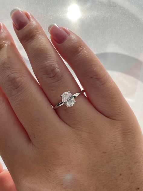 New In from our 2022 collection!  💎This simplistic but absolutely beautiful engagement ring features 1.5CT oval cut  white D color Moissanite stone on a minimal 1.8mm sterling silver band. Truly elegant and timeless design.  💎Made of high quality sterling silver and plated with rhodium it will not rust or turn your finger green. Center stone size - 6mm*8mm(1.5Ct) Color Grade - D Clarity Grade- VVS1 Cut: Excellent  Material:  Fine Sterling Silver 925 Plating: Rhodium    💎Comes with authenticit Engagement Rings Silver Dainty, Silver Oval Moissanite Engagement Ring, Timeless Engagement Ring White Gold, Simple Wedding Rings Silver Oval, All Silver Engagement Ring, 1ct Oval Engagement Ring Silver, Oval Silver Band Engagement Ring, Small Dainty Engagement Rings Silver, 1 5 Carat Oval Engagement Ring Silver Band