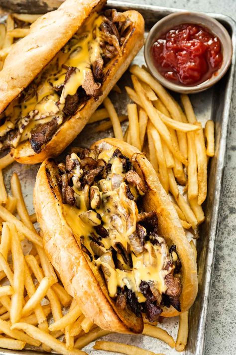 Philly Cheesesteak made in your own kitchen with tender rib eye steak, caramelized onions, and Cheese Whiz, in a buttery hoagie roll. Philly Cheese Steak Sandwich, Philly Cheese Steak Recipe, Cheese Whiz, Philly Steak, Steak And Onions, Cheesesteak Recipe, Dinner Then Dessert, Cheese Steak Sandwich, Cheese Steak