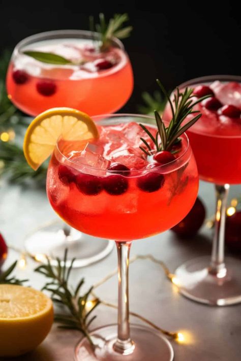 sparkling glass of Santa's Spritz Christmas Cocktails, with rich red cranberry juice, bubbly prosecco, and a hint of ginger gin, garnished with a sprig of rosemary. Loaded Mashed Potato Balls, Orange Mocktail, Rhubarb And Ginger Gin, Cranberry Mimosa, Apple Cider Mimosa, Cranberry Margarita, White Cranberry Juice, Rosemary Simple Syrup, Spritz Cocktail