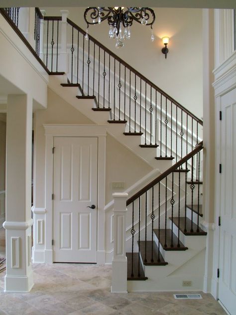 an example of a white newel post with stained handrail to match wood flooring and iron baluster (though diff style) درابزين السلم, درج السلم, Wrought Iron Stair Railing, Stair Makeover, Iron Stair Railing, Iron Staircase, Stairs Makeover, Wrought Iron Stairs, Railing Ideas