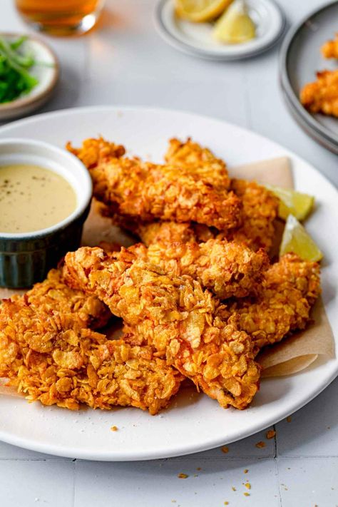 Corn Flakes Chicken Tenders is a simple recipe for a crunchy, juicy, delicious dinner. Make them in an over, air fryer, or deep-fry them. The chicken is juicy and tender, and the outside crust creates texture, crunchiness, and a beautiful golden layer. You can easily prepare these Chicken tenders in three ways. Make them in an oven or air fryer, or deep fry them in a skillet with oil. Choose a light side dish like a salad or french fries to serve. We adore these with a simple honey mustard ... Corn Flakes Chicken, Cornflake Chicken, Crunchy Chicken, Chicken Tender, Baked Corn, Honey Mustard Sauce, Deep Fry, Mustard Sauce, Duck Recipes