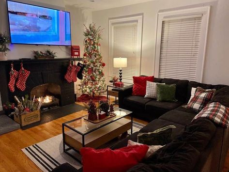 Gather the family to watch your favorite holiday movies in the comfort of a cozy black L-shaped sofa. The dark tones of the sofa and the gorgeous jet-black fireplace are contrasted by the traditional green, white, and red colors of Christmas presented by stockings, a Christmas tree, and soft cushions. Place simple holiday decor such as a tiny Christmas tree and house on a stylish coffee table...   Image: vintagemadememories Christmas Living Room Decorations, Olive Living Rooms, Grey Stone Fireplace, Black Couches, Holiday Living Room, Simple Holiday Decor, High Ceiling Living Room, Living Room Decorations, Living Room Christmas