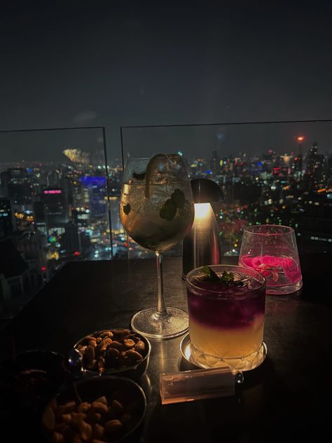 Drinks at a Table, Luxury at a Rooftop Bar, Skyscraper, Bangkok, NYC Vibes #DrinksAtATable #LuxuryRooftopBar #SkyscraperViews #BangkokNightlife #NYCVibes #TableDrinks #RooftopDrinkSpecials #CityscapeViews #RooftopMixology #ManhattanNights #BangkokSkyline #NightlifeEscapes #CocktailHour #UrbanGlamour #MetropolitanElegance #SkyHighSips #luxurylife #drinks #cocktails #aestheticcocktails Thailand Rooftop Bar, Rooftop Vibes Aesthetic, Nyc Rooftop Bar Aesthetic, Rooftop Bar Aesthetic Night, Drink With Friends Aesthetic, Rooftop Dinner Aesthetic, Rooftop Bar Instagram Pictures, Bangkok Rooftop Bar, Luxury Rooftop Bar