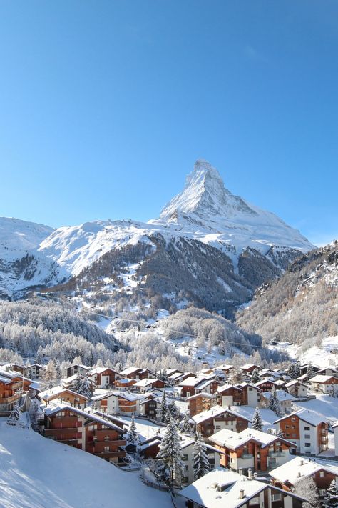 Snow-covered chalets in front of the Matterhorn Ski Resort Switzerland, Switzerland Ski Resort, Zermatt Switzerland Spring, Skiing In Switzerland Swiss Alps, Winter Switzerland Aesthetic, Switzerland In The Winter, Zermatt Aesthetic, Switzerland Winter Aesthetic, Switzerland Aesthetic Winter