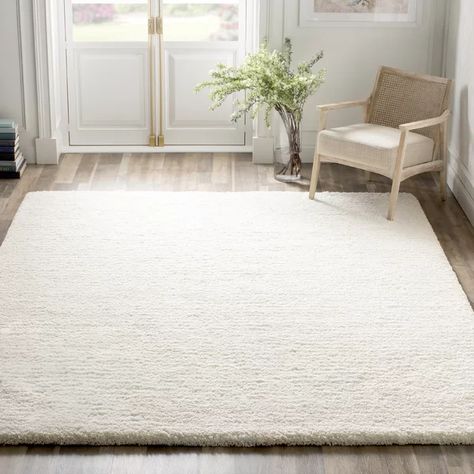 Set an approachable and on-trend foundation in your home with this shag rug. It features an understated and neutral ivory hue that sets the scene for any color palette in your living room or bedroom. Handmade in India from polyester with a cotton backing, this area rug has a long 1.57" pile height for a shag look. We recommend rolling out a rug pad underneath this design to keep it safely in place and prevent slipping and sliding.Hand-curated by Kelly Clarkson. Area Rug Sets, Cheap Rugs, Solid Color Rug, Ivory Area Rug, Kelly Clarkson, Shag Area Rug, Silver Area Rug, Rug Sets, Handmade Area Rugs