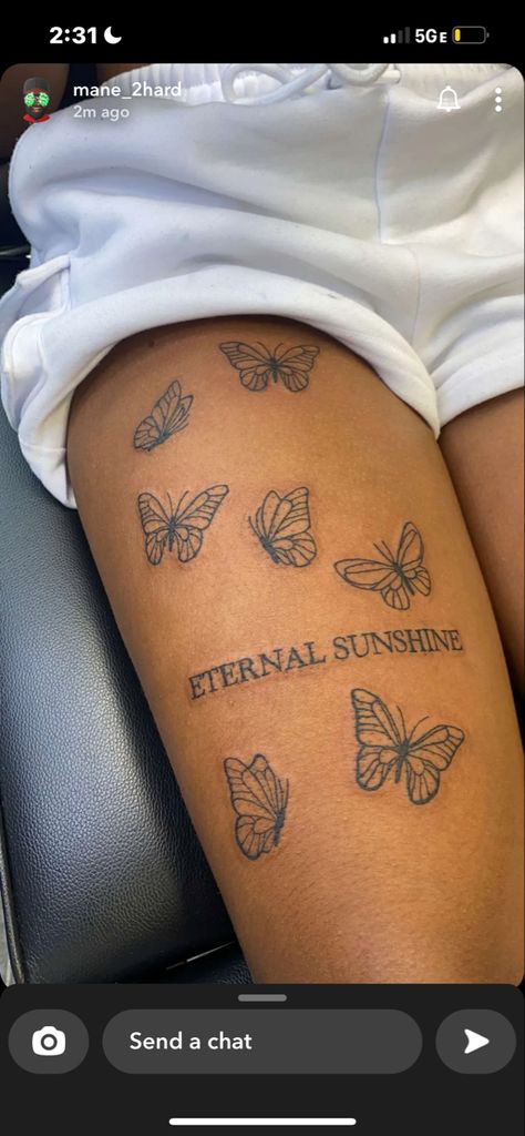 tattoo reading “eternal sunshine” with 7 butterflies Tattoo On Your Thigh, Thigh Tats For Women Baddie, Middle Leg Tattoo, Cool Thigh Tats For Women, Cute Tattoos For Black Women On Leg, Above The Knee Tattoos Black Women, Tattoo Ideas Female Meaningful Leg, Word Tattoos For Women On Thigh, Tattoo Behind Thigh Women