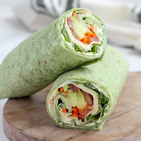 Our Veggie Wraps are made with a delicious, homemade herbed cream cheese and are packed with lots of fresh vegetables. It's a healthy and easy recipe that can be made ahead and are perfect for packed lunches! Green Wraps Tortilla, Wrap Rolled Sandwiches, Cream Cheese Veggie Wrap, High Protein Veggie Wraps, Easy Veggie Sandwiches, Easy Veggie Wraps, Easy Vegetable Recipes Quick, Spinach Herb Wrap Recipes, Veggie Burrito Wraps