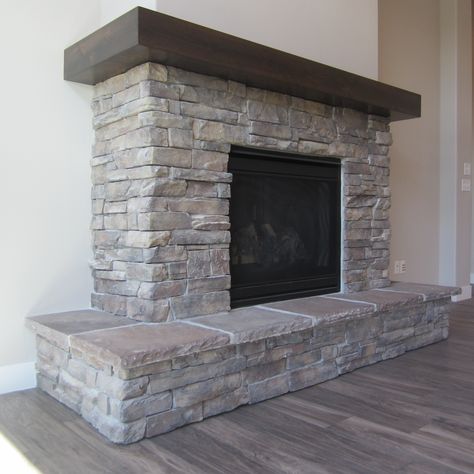 Short Stone Fireplace, Wrap Around Hearth Fireplace, Fireplace Mantels Wrap Around, Fireplace Raised Hearth Ideas, Fireplace With Wrap Around Hearth, Fireplace Wrap Around Mantle, Wrap Around Wood Mantle, Wrap Around Mantel Fireplace, Gray Rock Fireplace