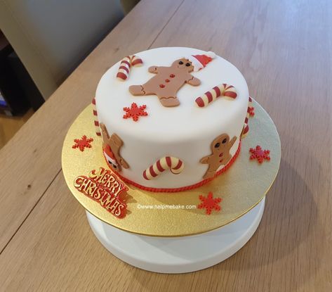 A gingerbread and candy cane theme christmas cake. Gingerbread Christmas Cake Decoration, Marzipan Cake Decoration Ideas, Candy Cane Christmas Cake, Gingerbread Man Birthday Cake, Christmas Cake Square, Gingerbread Theme Cake, Fondant Christmas Cake Ideas, Gingerbread Christmas Cake, Christmas Cake Fondant Decorating Ideas