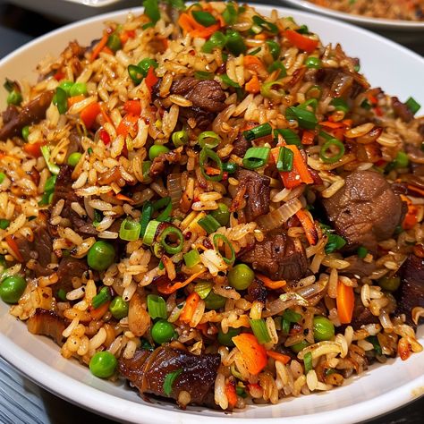 🍚 Indulge in the rich flavors of Oxtail Fried Rice! 🍖✨ #OxtailFriedRice #FlavorfulEats Oxtail Fried Rice Ingredients: Oxtail, cooked and shredded (1 lb) Cooked rice (4 cups) Garlic, minced (3 cloves) Onion, chopped (1) Carrots, diced (1 cup) Peas (1 cup) Soy sauce (3 tbsp) Oyster sauce (2 tbsp) Sesame oil (1 tbsp) Green onions, chopped (1/2 cup) Oil (for frying) Instructions: Heat oil in a large pan or wok over medium heat. Sauté garlic and onion until fragrant. Add carrots and peas, cook... Oxtail Fried Rice, Fried Oxtails, Twist Recipes, Fried Rice Ingredients, Recipes With Rice, Fried Recipes, Soul Food Dinner, Cooked Rice, Tasty Recipes Videos