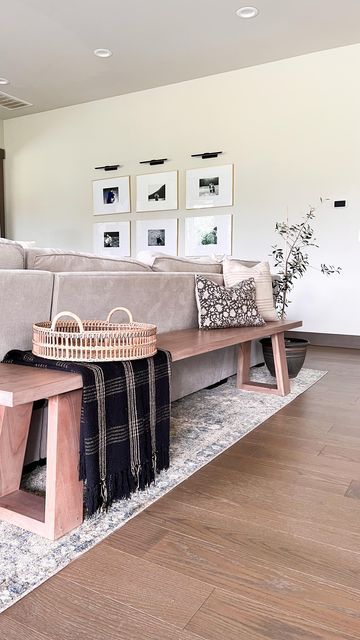 Elisabeth Yeary | organic modern | on Instagram: "Reasons I love a bench over the traditional console table behind the couch: ▫️provides additional seating ▫️it’s perfect for open concept homes ▫️the low profile makes your space feel more open. ▫️gives your guests somewhere to leave their bag . . . . . #naturaldecor #ltkhome #ltkstyletip #neutraldecor #behindthesofa #homestyling #openconcept #benchstyling" Bench Seating Family Room, Couch Placement Ideas Open Concept, Console Table Bench, Living Room Table Behind Couch, Console Table Sectional, Wooden Bench Behind Sofa, Back Of Couch Bench, Behind The Couch Bench Decor, Open Concept Sofa Table