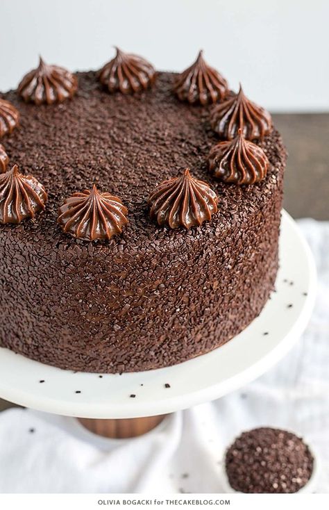 Chocolate Truffle Cake - a chocolate layer cake recipe with dense, moist chocolate cake, silky chocolate truffle frosting and chocolate flakes | by Olivia Bogacki for TheCakeBlog.com Chocolate Flakes, Chocolate Layer Cake Recipe, Truffle Cake, Coconut Dessert, Chocolate Truffle Cake, Delicious Deserts, Cake Party, Rich Chocolate Cake, Chocolate Layer Cake