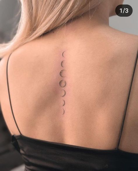 333 Minimalist moon phase tattoo along the spine of a woman's back, showcasing lunar cycle in a delicate design. | Sky Rye Design Moon Down Spine Tattoo, Moon Phases Tattoo On Back, Moon Line Tattoo Design, Phases Of The Moon Tattoo Back, Moon Phases Tattoo Placement, Moon Phases On Spine, All Back Tattoo Women, Moon Cycle Back Tattoo, Tattoo In Back For Women