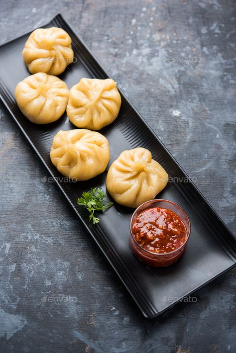 Momos by stockimagefactory. Traditional dumpling momos food from Nepal served with tomato chutney over moody background #Sponsored #dumpling, #momos, #food, #Momos Veg Momos Photography, Momo Plating, Momos Wallpaper Food, Momos Plating Ideas, Momo Food Photography, Momos Photoshoot, Momos Food Photography, Dumpling Plating, Momos Picture