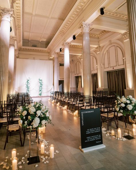 A wedding ready to welcome guests from every angle 🖤 Alana & Ryan | 10.28.2023 Florals | @tularosefloralevents Venue | @treasuryontheplaza Planning | @coastalcelebrationsstaug Photography | @angelita_photo Signage | @andimejiaco Rentals | @stjohnsilluminations ✿ #weddingflorist #floridaweddingflorist #staugustinewedding #staugustingweddings #staugweddings #thetreasuryontheplaza #thetreasury #treasurywedding #weddingflowers #moodyweddinginspo #floraldesigner #weddingarrangement #flor... Ceremony Flowers Indoor, Elegant Wedding Ceremony Decor, Ceremony Decorations Indoor, The Plaza Wedding, Wedding Ceremony Design, Aisle Florals, Ceremony Decor Ideas, Treasury On The Plaza, Floral Arbor