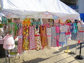 Aprons Aprons Aprons. Just looking at this makes me happy. Craft Show Booths, Craft Show Booth, Craft Booth Display, Retro Revival, Craft Fairs Booth, Craft Apron, Boutique Display, Craft Booth Displays, Craft Stalls