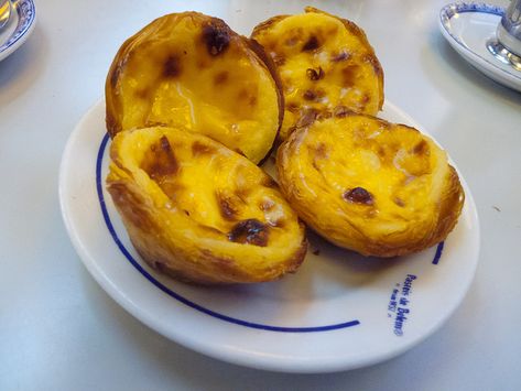 Pastéis de Nata: Authentic Portuguese Custard Tarts Recipe – Devour Tours Affordable Places To Travel, Portuguese Custard Tart Recipe, Natas Recipe, Portuguese Custard Tarts, Portuguese Tarts, Bologna Food, Portuguese Dessert Recipes, Custard Tarts Recipe, Portuguese Egg Tart