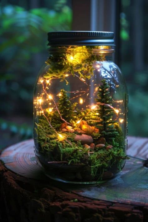 Capture the fairy light in a mason jar. Place a strand of tiny LED lights inside, interwoven with moss and miniatures. #DIY #FairyGarden #Garden #Decor Fairy Lights Crafts Diy Projects, Fairy Mason Jars Diy, Fairy Diy Decor, Tiny Mason Jar Ideas, Fairy Lights In Jar, Fairy Garden Jar, Glowing Mushrooms Diy, Fantasy Room Decor Diy, Diy Fairy Lights Decor