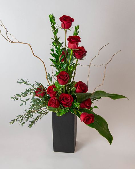 About Rose Amore   We put a twist on the classic dozen roses to create this modern ascending spiral rose design! The Rose Amore oozes elegance and romance. The tower of 12 roses dances with twigs of curly willow and textural greenery in a contemporary matte black ceramic vase.   Approximate dimensions: 14" width, 34" height  roses, medium stem rose, rose, dozen roses, 24 roses, red roses, pink roses, white roses, yellow roses Red Rose Arrangements, Valentine Flower Arrangements, Vasos Vintage, Black Ceramic Vase, Floral Art Arrangements, 12 Roses, Rose Floral Arrangements, Roses Yellow, Small Flower Arrangements