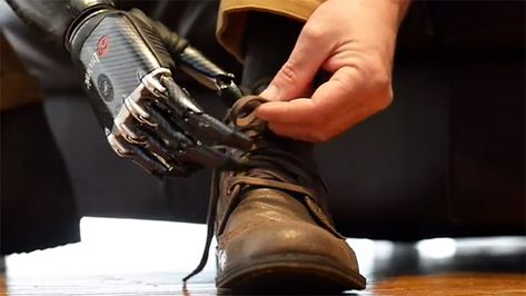 An upgrade to the high-tech BeBionic3 prosthetic hand is enabling one man to perform incredibly sophisticated operations such as dealing cards, tying his own shoelaces and touch typing on a computer keyboard. Nigel Ackland’s Terminator-like mechanical limb, designed by RSL Steeper, has been reinforced with stainless steel and titanium, and it’s now equipped with insulating pads that avoid picking up heat or static electricity. Prosthetic Hand, Robot Hand, Sense Of Touch, Hand Tie, The Future Is Now, Future Tech, Tie Shoelaces, Future Technology, Terminator