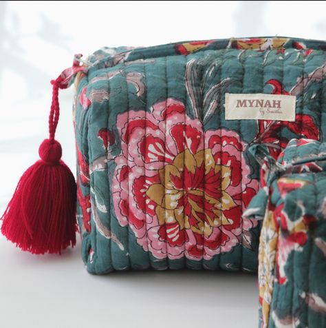 Introducing our exquisite emerald hand block printed quilted travel bag. Featuring a SINGLE large pouch measuring 10”x 4.5”x 4” with a red pom-pom, it offers ample space for all your essentials. Makes an unforgettable gift! Waterproof Lining: Engineered with practicality in mind, our travel bag boasts a waterproof lining, ensuring your belongings remain safeguarded from unexpected spills or inclement weather. Travel with peace of mind, knowing your essentials are shielded from moisture. Machine Washable and Tumble Dry: Enjoy effortless maintenance. Our travel bag is machine washable, allowing for quick and hassle-free cleaning. Simply tumble dry on low, and it's ready for your next adventure. Travel Pouch Set, Leather Totes, Large Pouch, Small Pouch, Travel Organizer, Amazing Travel, Small Pouches, Printed Quilt, Makeup Bags Travel