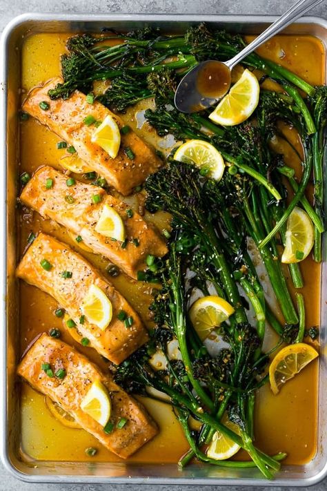 overhead shot of Sheet Pan Honey Lemon Salmon & Broccolini after baking with spoon Lemon Salmon Recipes Baked, Honey Broccoli, Lemon Salmon Recipes, Dinner Staples, Clean Eating Salmon, Harissa Salmon, Honey Lemon Salmon, Salmon Recipe Pan, Fillet Recipes