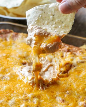 This Cream Cheese Bean Dip recipe is our new favorite Mexican dip! With sour cream, cream cheese, Mexican cheese, refried beans, and salsa, it is the perfect dip to eat with chips, tacos, or any other Mexican dish! SOO good!! Cheese Bean Dip, Bean Dip Recipes Refried, Cream Cheese Bean Dip, Bean Cheese Dip, Party Food Ideas For Adults, Refried Bean Dip, Chip Dips, Bean Dip Recipe, Best Dip Recipes