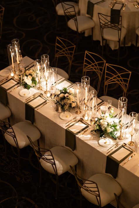 Elegant trios of floral arrangements and gold candlesticks with taper candles along the length of a long guest table. PC: Ann Coen https://www.anncoen.com/photography Long Table Wedding Decor Candles, Tall Wedding Centerpieces Long Table, Gold Taper Candles Wedding, Tall Candle Centerpieces Wedding Long Table, Wedding Centerpiece Candlestick, Floral And Candle Table Decor, Taper Candle Centerpiece Wedding Long Table, Candle Placement Ideas, Taper Candle Centerpiece Wedding Round Table