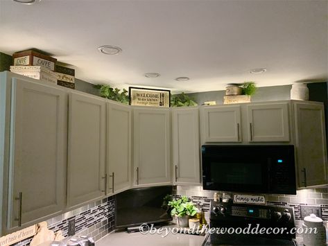 Decorating above kitchen cabinets - Beyond the Wood, DIY tips and tricks Kitchen Top Cupboard Decor, Upper Cupboard Decor, Kitchen Decorating Ideas On Top Of Cabinets, Top Of Cabinet Lighting Kitchen, Above Cupboards Decor Kitchen, Top Of Kitchen Cupboard Decor, Decorating Ideas For Above The Cabinets, Decorate Upper Kitchen Cabinets, Kitchen Decor Over Cabinets Ideas