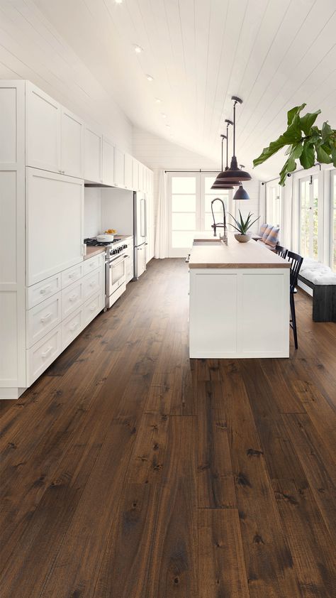 To get the most out of those bright white cabinets, we’ve paired a medium brown hardwood floor: Abella Acacia Moderna. This warm engineered wood floor also contrasts perfectly with the lighter wood countertops for a complete look, and the sophisticated feel of the smoked oak floors brings the minimalist design of this kitchen to life. Wood Floor Colors, Hardwood Floor Colors, Wooden Countertops, Wood Floor Kitchen, Dark Hardwood, Hardwood Floors Dark, Brown Floors, Dark Wood Floors, Flooring Trends