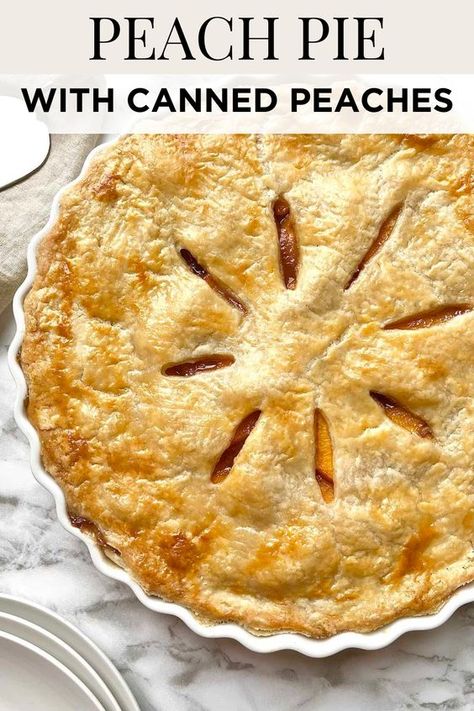 This fresh peach pie recipe is made with a homemade flaky pie crust that's baked to perfection with a sweet peach pie filling made from canned peaches, sugar, cinnamon, nutmeg, vanilla extract, and lemon juice. Save for later! Peach Pear Pie, Canned Peach Pie Recipes Easy, Peach Pie With Jarred Peaches, Easy Peach Pie Filling Canned, Southern Peach Pie Recipes, Peach Cherry Pie, Sour Cream Peach Pie, Peach Apple Pie, Peach Pie From Frozen Peaches