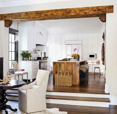 Kitchen opens to sunken dining room with rustic wood beam with corbels featuring glossy black pedestal table with natural linen slipcovered ... Traditional Kitchen, 1900s Home, Sunken Living Room, Living Comedor, Kitchen Views, Wood Beams, Kitchen And Dining, Kitchen Organizing, Open Concept