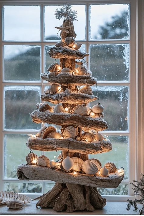 Who says Christmas can't have a beach vibe? Learn how to incorporate coastal elements into your holiday decor for a unique and refreshing take on Christmas. From seashell ornaments to driftwood trees, get inspired! Some of the links in my articles are affiliate links. If you make a qualified purchase from one of my links I will make a small commission at no cost to you. Thank you for your support!!! Driftwood Christmas Tree Decoration, Beachwood Christmas Tree, Xmas Driftwood Ideas, Blue Beach Christmas Decor, Nautical Christmas Decorations, Beach Xmas Decorations, Seaside Christmas Decor, Shell Trees Coastal Christmas, Coastal Christmas Centerpieces