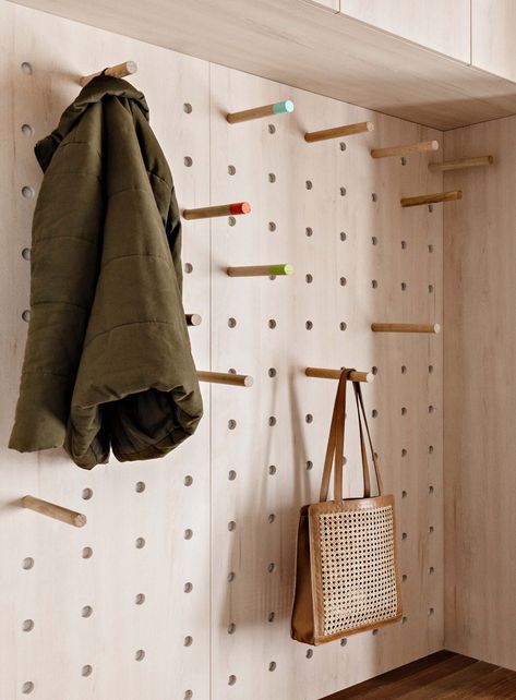 A Combined Mudroom And Laundry Room With A Pegboard Wall Is A New Addition To This Remodeled Home