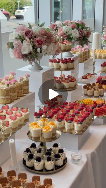 SheikhArts Desserts on Instagram: "Libby & Moore 🤍   Dessert table consisted of shot glass desserts, cakelettes, pavlova and fruit platters.   Location: Hilton - Utilita Bowl  #desserts #cheesecakes #desserttable #fruitplatter #minidesserts #wedding #minicakes #cakelettes" Fruit And Cheese Table Wedding, Fruit Tables Ideas, Dessert Tables Birthday, Mini Desserts Wedding Display, Candy And Fruit Table Ideas, Desserts For 50th Birthday Party, Dessert Platter Wedding, Dessert Table For Quinceanera, Dessert Buffet Ideas Diy