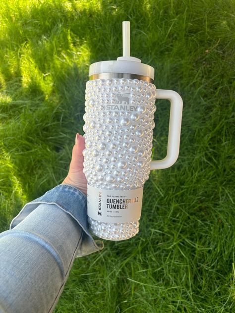 DESCRIPTION: This is for the purchase of 1, 40oz, 30oz or 20oz  Stanley quencher with hand laid pearls as shown. Please note that the logo on this cup is not covered in crystals. If you would like your cup to have the logo covered in crystals it is an extra charge. Please contact us with your color preference for the logo and for a quote to have the logo covered.  BASE CUP: Example photo is shown with a 40oz cup. Please note that the 20oz option does not come with a handle. We offer sizes 20,30 Stanley Cups Aesthetic, Custom Stanley Cup, Bedazzled Stanley Cup, Cute Stanley Cups, Stanley Decor, Stanley Cup 40 Oz, Stanley Products, Trendy Water Bottles, Bling Ideas