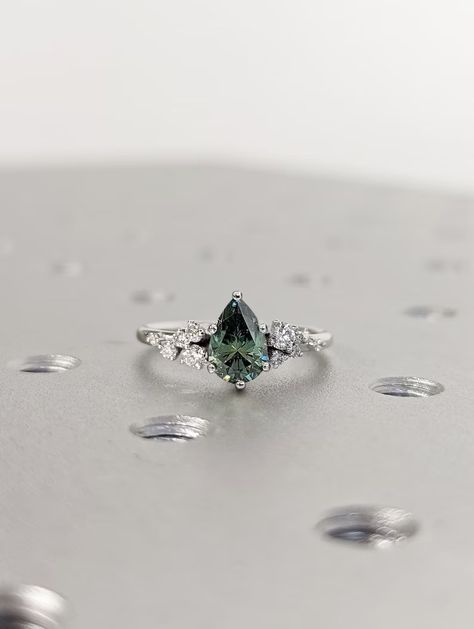 MAIN STONE
Type: Braverman Moissanite
Cut: Pear
Color: Green
Clarity: VVS

#Pear #Cut #Green #Moissanite #Ring #Vintage #Moissanite #Engagement #Ring #Solid #Gold #Unique #Snowdrift #6 #Prongs #Engagement #Ring #Diamond #Wedding #Ring #18k #white #gold #ring #personalized #ring #alternative #ring #anniversary #ring #bridal #ring #cluster #ring #dainty #ring #engagement #gifts #engagement #rings #gift #for #her #promise #ring #for #her #rose #gold #snowdrift #ring Silver Band Engagement Ring Unique, Silver Engagement Rings Diamond, Green Gem Wedding Ring, Cottagecore Wedding Ring Silver, Simple Silver Engagement Rings Unique, Green Stone Engagement Ring Silver, Silver Engagement Rings Colored Stone, Earthy Engagement Rings Silver, Emerald And Silver Engagement Ring