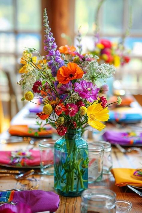 Create a magical atmosphere with wildflower centerpieces at your wedding. These simple and beautiful flower arrangements, perfect for round and rectangle tables, use mason jars or vases, offering DIY charm for showers and birthdays.Clear chat How To Wedding Floral Arrangements, Vase With Wildflowers, Flower Jars Wedding, Diy Flower Table Decor, Flower Arrangements Diy Birthday, Bridal Bucket Flower, Spring Flower Centerpieces Diy, Wildflower Arrangements Diy, Round Table Flower Decor