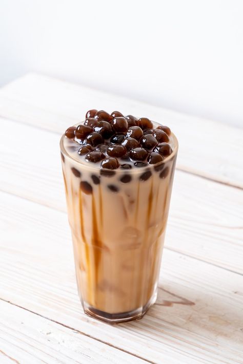 A glass of iced boba tea with layers of tea, milk, and a generous amount of dark tapioca pearls on top. Lychee Mocktail, Boba Flavors, Pina Colada Mocktail, Bubble Tea Flavors, Boba Recipe, Brown Sugar Syrup, Boba Drink, Fruit Jelly, Watermelon Juice