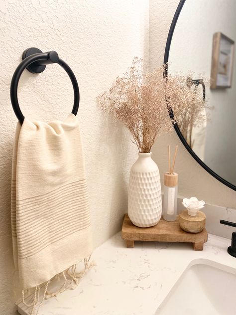 Neutral creamy + wood bathroom decor for spring Neutral Restroom Decor, Small Counter Space Bathroom, Neutral Bathroom Aesthetic, Bathroom Earthy Decor, Toilet Top Decor Ideas, Half Bathroom Decor Minimalist, Earth Tone Bathroom Decor, Neutral Apartment Bathroom, Neutral Aesthetic Bathroom