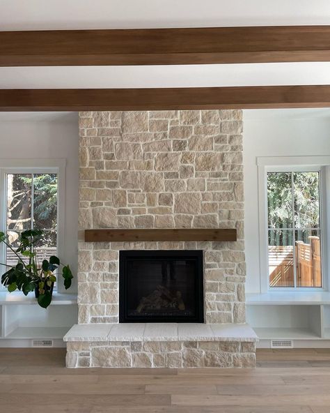 Creamy, beige, sandy stone fireplace in a living room using Casa Blanca RoughCut from Eldorado Stone available at I-XL Building Products. Rockwall With Fireplace, Stone Chimney Interior, Stone Tiled Fireplace, Farmhouse Stone Fireplace Ideas, Classic Stone Fireplace, Stone Fireplace With Bench Seating, Short Stone Fireplace, Stone Fireplace With Mantle And Tv, Stone Fireplace Small Living Room