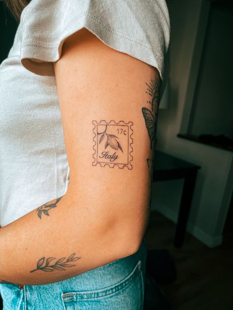 Fine line detailed Italy lemon stamp tattoo on arm Lemon Stamp, Cleveland Tattoo, Italy Stamp, Italy Tattoo, Stick And Poke Tattoo, Stamp Tattoo, Small Girly Tattoos, Hibiscus Tattoo, Flower Tattoo Sleeve